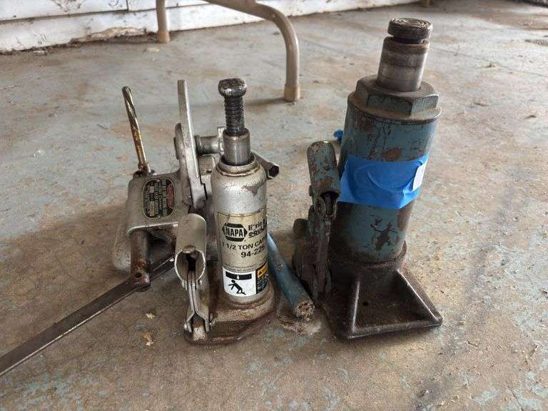 Two bottle jacks and drill bit sharpener image