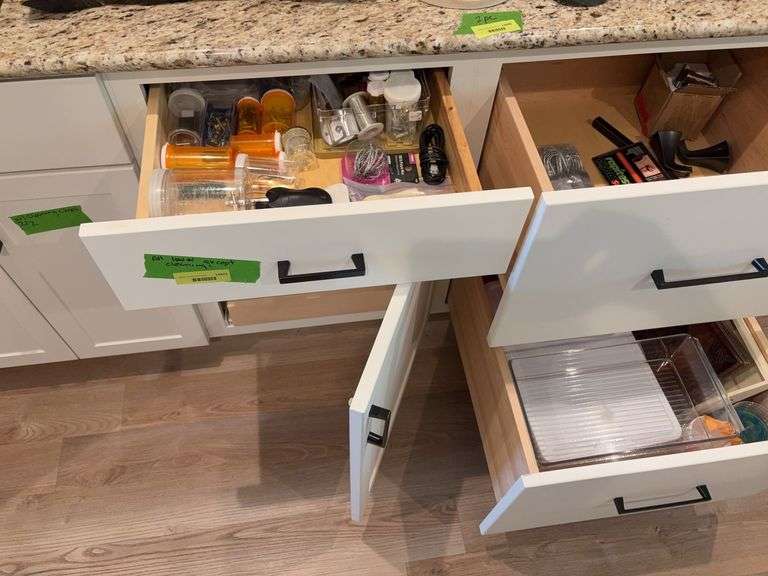 Junk drawer items includes screws, garden clips, “T” labels, peg hooks, storage containers, serving dishes, etc image