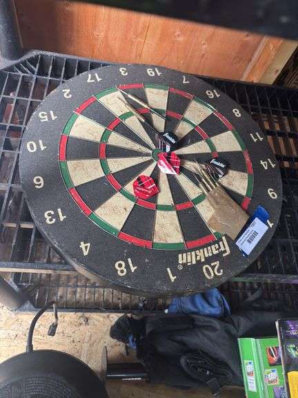 Old-fashioned Franklin brand dartboard with darts image