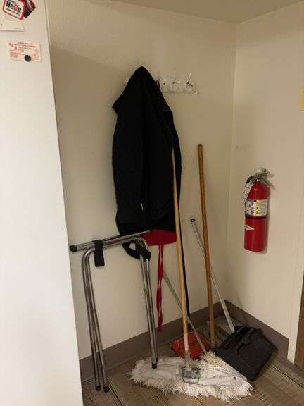 Serving tray rack, mops, dust pans, apron, coat image