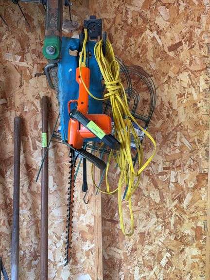 Electric hedge trimmers, drop cord, wire garden fence and kneeler image