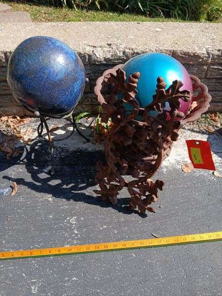 Two gazing balls, cast iron stand and a cast iron wall hanger image