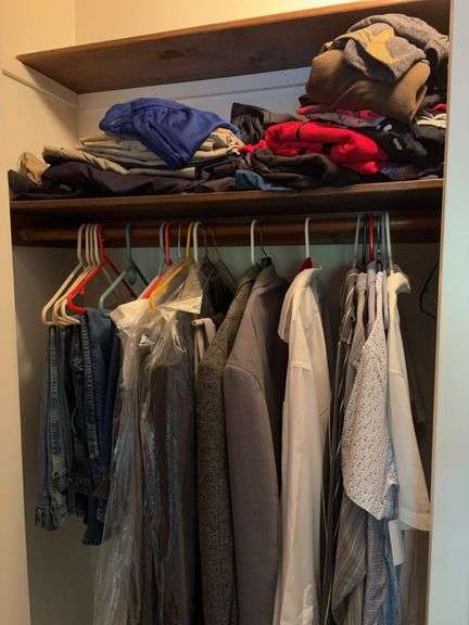 Closet full of men’s and women’s clothes image