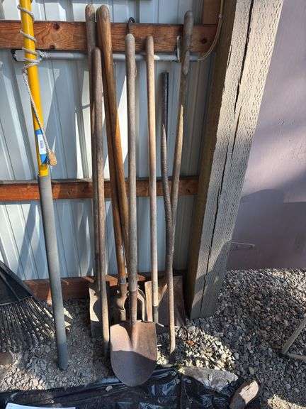 Rake, post hole digger, shovel, bar and other yard tools image