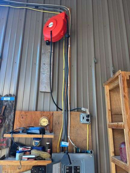 Ironton retractable extension cord reel attached to the wall bring tools to remove image