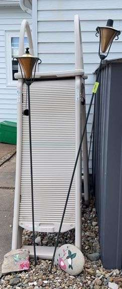 Two tiki torches and hand painted hummingbird rocks