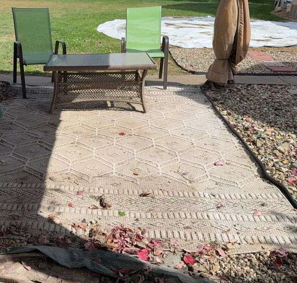 Plicker glass topped coffee table, two metal patio chairs and approx 8x10 outdoor rug