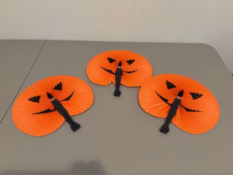 Three paper fans with Jack-o-lantern faces, see photos for condition image