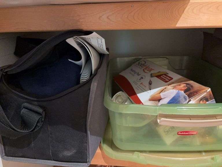 Heating pad, plug in air fresheners, curling irons, bag and Phillips Respironics cpap machine, unsure if complete image