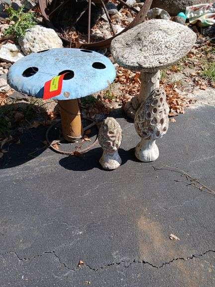 Three cement mushrooms and a metal one 🍄🍄‍🟫 image