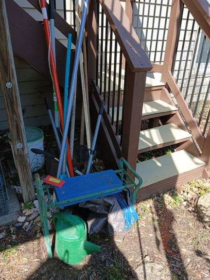 Long handled yard tools, poly tarp, water can, hose brush image