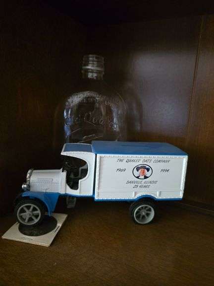 Quaker Oats coin, truck bank and glass bottle image