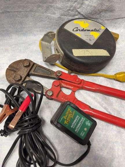 Lot six items. Craftsman 42-piece socket set SAE and metric, includes hex and torque bits, small dolly 11x16 with 2-in Wheels, Ryobi jigsaw corded appears unused, Cordmetric electric cord winder, battery tender and 24-in bolt cutter image