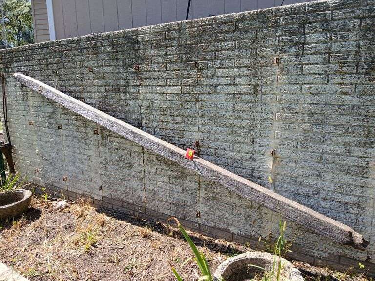 Approx 13’ long wooden water pipe and cast iron wheel center image