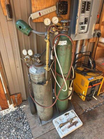 Oxy acetylene tanks on cart with gauges and hoses image