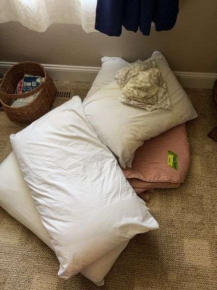 Four pillows and twin size down comforter image