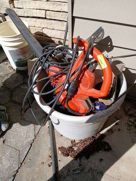 Handled tub w black & decker blower, loppers, wood chunks, etc image