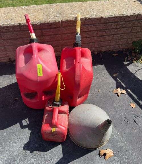 Three gas cans and a funnel image
