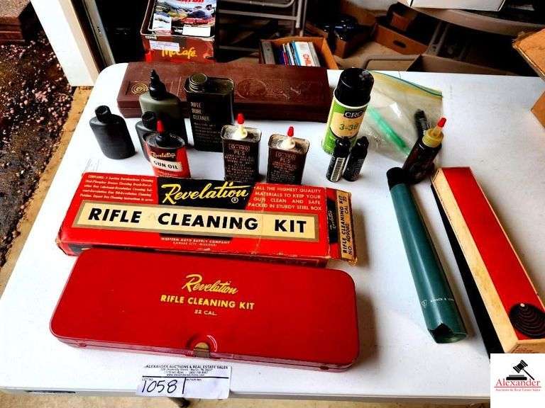 VINTAGE REVELATIONS RIFLE CLEANING KIT- IN RED METAL CASE-IN ORIGINAL BOX-BOX HAS TEAR-VINTAGE METAL AND PLASTIC GUN CLEANING CAN-REVELATIONS GUN OIL-ARMY CANS OIL-10 POWER TELESCOPE-BROKEN(GARAGE) image