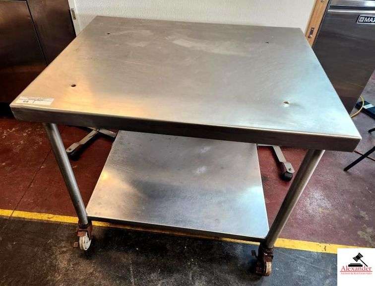 STAINLESS TABLE W/ LOWER GALVANIZED SHELF HAS 4 HOLES ON TOP (KITCHEN) image