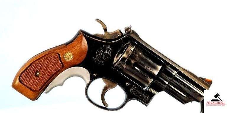 SMITH AND WESSON MD. 19-2 REVOLVER - S&W 357 MAG. - 6 SHOT - 2 3/4" BBL - S&W CHECKERED WOOD GRIPS - VERY GOOD CONDITION - RECEIVER BLUING WORN RIGHT SIDE BELOW CYLINDER - VERY LITTLE CARRY WEAR - CYLINDER SHOWS CARRY WEAR AND CIRCLE - BLUING WORN NEAR MUZZLE BOTH SIDES - ADJUSTABLE REAR SIGHT - ORANGE FRONT SIGHT - DOUBLE ACTION - S&W MD. 19 BLUE BOX - BOOK - LOCK - EXCELLENT CONDITION - S/N K792191 image