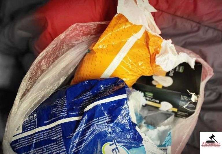 (2) SLEEPING BAGS - RED AND ORANGE - BAG OF TOWELS AND WASH CLOTHES - DEPENDS AND LADIES PADS - (GARAGE)