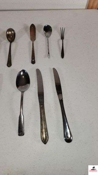 (35) TOTAL PCS. - (5) SALAD FORKS - (5) DINNER KNIVES - (3) SPPONS - (4) SALAD FORKS - (3) DINNER FORKS - (4) TEASPOONS - PICKLE FORK - BUTTER KNIFE - SUGAR SHELL - MISCELLANEOUS SPOONS AND KNIVES - (MAPLE HUTCH GREAT ROOM)