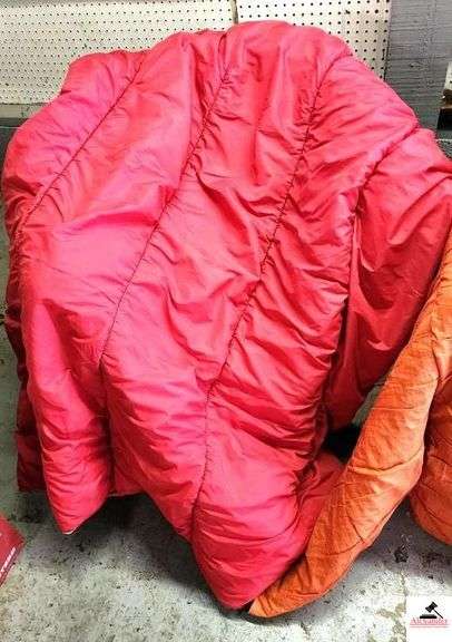 (2) SLEEPING BAGS - RED AND ORANGE - BAG OF TOWELS AND WASH CLOTHES - DEPENDS AND LADIES PADS - (GARAGE)
