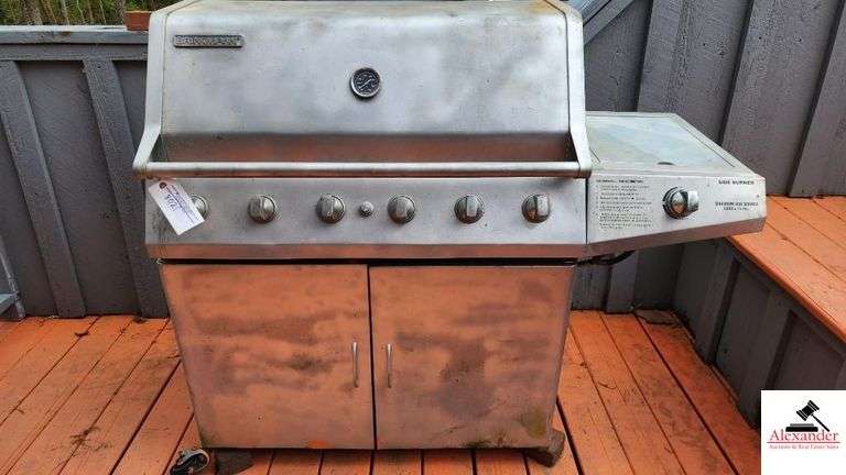 BRINKMANN GAS GRILL - TOP IS 17 1/2" DEEP X 35 1/2" WIDE - SIDE BURNER - APPEARS BEEN PAINTED - ROLLING FEET MISSING / BENT - PROPANE TANK INCLUDED - COVER - (PATIO)
