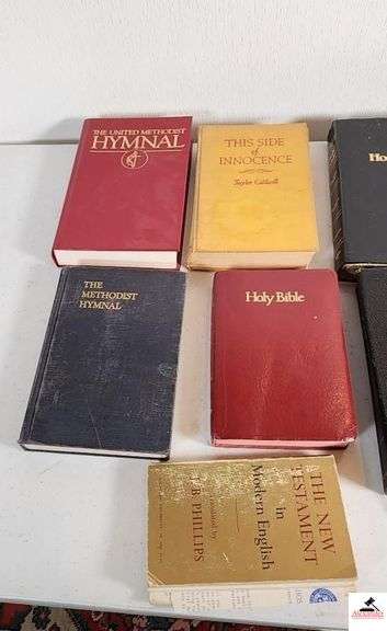 HOLY BIBLES AND HYMNALS - UNITED METHODIST HYMNALS - THE NEW TESTAMENT IN MODERN ENGLISH TRANSLATED BY J.B PHILLIPS SOME PAGES OFF OF THE SEAM - THIS SIDE OF INNOCENCE BY TAYLOR CALDWELL COPYRIGHT 1946 - ONE BIBLE COVER UNATTACHED - HOLY BIBLE KING JAMES VERSIONS - (TRAILER)
