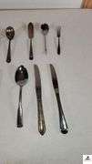 (35) TOTAL PCS. - (5) SALAD FORKS - (5) DINNER KNIVES - (3) SPPONS - (4) SALAD FORKS - (3) DINNER FORKS - (4) TEASPOONS - PICKLE FORK - BUTTER KNIFE - SUGAR SHELL - MISCELLANEOUS SPOONS AND KNIVES - (MAPLE HUTCH GREAT ROOM)