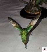 (2) MARURI HUMMINGBIRD FINE  PORCELAIN AND BRONZE STUDIO DESIGN H8905 ANNA'S HUMMINGBIRD WITH LILY, CIRCA 1989, BROKEN LIMB AND A RUBY THROATED HUMMINGBIRD WITH ORCHAD, LEAF MISSING OR BIRD, WING BROKEN - (2) HUMMINGBIRDS - (GREAT ROOM)