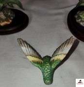 (2) MARURI HUMMINGBIRD FINE  PORCELAIN AND BRONZE STUDIO DESIGN H8905 ANNA'S HUMMINGBIRD WITH LILY, CIRCA 1989, BROKEN LIMB AND A RUBY THROATED HUMMINGBIRD WITH ORCHAD, LEAF MISSING OR BIRD, WING BROKEN - (2) HUMMINGBIRDS - (GREAT ROOM)