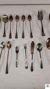 (24) TOTAL PCS. - (5) SUGAR SHELLS - (4) ICE TEA SPOONS - (6) SALAD FORKS - (2) ICE TEA SPOONS -  PICKLE FORK - BUTTER KNIFE - TEA SPOON - SERVING FORK - ETC. - (MAPLE HUTCH GREAT ROOM)