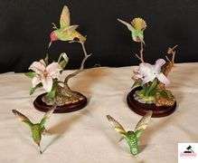 (2) MARURI HUMMINGBIRD FINE  PORCELAIN AND BRONZE STUDIO DESIGN H8905 ANNA'S HUMMINGBIRD WITH LILY, CIRCA 1989, BROKEN LIMB AND A RUBY THROATED HUMMINGBIRD WITH ORCHAD, LEAF MISSING OR BIRD, WING BROKEN - (2) HUMMINGBIRDS - (GREAT ROOM)