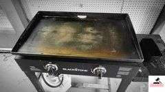 BLACKSTONE GRILL - TOP IS 18" X 29" -PLASTIC COVER W/ HOLE  - (GARAGE)