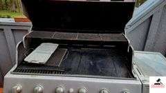 BRINKMANN GAS GRILL - TOP IS 17 1/2" DEEP X 35 1/2" WIDE - SIDE BURNER - APPEARS BEEN PAINTED - ROLLING FEET MISSING / BENT - PROPANE TANK INCLUDED - COVER - (PATIO)