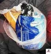 (2) SLEEPING BAGS - RED AND ORANGE - BAG OF TOWELS AND WASH CLOTHES - DEPENDS AND LADIES PADS - (GARAGE)