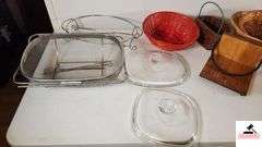 WOOD SERVING TRAY - ONE RIM NEEDS GLUING BACK ON - SERVING BASKETS, SOME SHOW WEAR - SERVING TRAY HAS PIECE OF TAPE ON IT - GLASS LIDS - SERVING RACK - ROUND WOVEN BASKET WITH LID - SHOWS WEAR - (UTILITY ROOM)