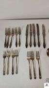 (35) TOTAL PCS. - (5) SALAD FORKS - (5) DINNER KNIVES - (3) SPPONS - (4) SALAD FORKS - (3) DINNER FORKS - (4) TEASPOONS - PICKLE FORK - BUTTER KNIFE - SUGAR SHELL - MISCELLANEOUS SPOONS AND KNIVES - (MAPLE HUTCH GREAT ROOM)
