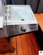BRINKMANN GAS GRILL - TOP IS 17 1/2" DEEP X 35 1/2" WIDE - SIDE BURNER - APPEARS BEEN PAINTED - ROLLING FEET MISSING / BENT - PROPANE TANK INCLUDED - COVER - (PATIO)