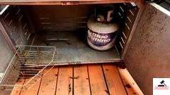 BRINKMANN GAS GRILL - TOP IS 17 1/2" DEEP X 35 1/2" WIDE - SIDE BURNER - APPEARS BEEN PAINTED - ROLLING FEET MISSING / BENT - PROPANE TANK INCLUDED - COVER - (PATIO)