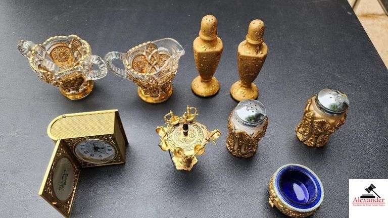PRESSED GLASS CREAMER AND SUGAR, SUGAR BOWL RIM IS CHIPPED - MOON AND STAR GOLD VASE - GOLD CHINA SALT AND PEPPERS - GOLD SALT AND PEPPER SHAKERS - LITTLE GOLD FOOTED DRESSER PC. WITH COBALT LINING - LITTLE PICKLE SPEARS, ONE MISSING - BULIFORD GIFTS MINI CLOCK IN GOLD CASE - (GARAGE)