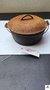 DUTCH OVEN WITH LID AND METAL VAIL - NEEDS CLEANING LID IS RUSTY - (TRAILER)