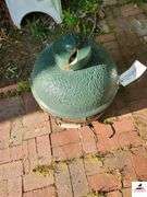 BIG GREEN EGG BARBEQUE GRILL - SMALL SIZE - GREEN COLOR - TOP COVER CRACKED HAS CHIP MISSING - (BESIDE GARAGE)