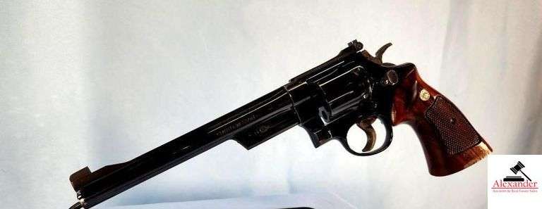 SMITH AND WESSON MD. 27-2 REVOLVER - 357 MAGNUM – 8 3/8” BBL – SMITH AND WESSON CHECKERED GRIPS – SMALL FINISH RUB ON BOTTOM OF GRIP - RECEIVER BLUING DEEP COLOR – VERY MINOR SCRATCH NEAR GRIPS ON RIGHT SIDE – CYLINDER SHOWS LITTLE BLUING WEAR – BARREL DEEP BLUE COLOR – SLIGHT BLUING WEAR NEAR MUZZLE POSSIBLY HOLSTER WEAR – NICE GUN – S/N N612430 image