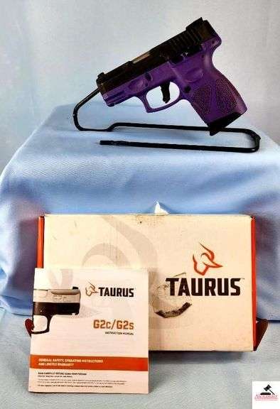 TAURUS INTERNATIONAL G2C PISTOL - 9MM CAL - SEMI-AUTO - BLACK OVER PURPLE - SLIGHT STAIN OVER GRIP - IN BOX WITH BOOK & LOCK - EXCELLENT CONDITION - S/N ABB295390 image