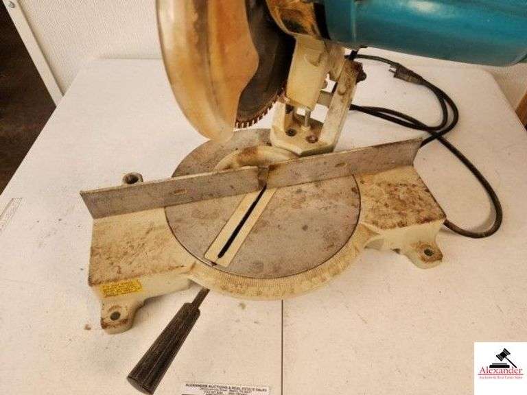 MAKITA LS1030 10" MITER SAW 50-60HZ - 4600 RPM - SAW DOES RUN - NEEDS CLEANING - RUBBER CORD IS LOOSE AT BASE OF SAW - (SHOP) image
