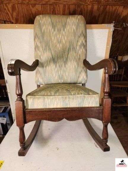 HIGHBACK WOOD ROCKER UPHOLSTERED SEAT AND BACK - ONE ARM HAS A DENT - NEEDS CLEANING - SHOWS WEAR - DUSTY - (UPSTAIRS) image
