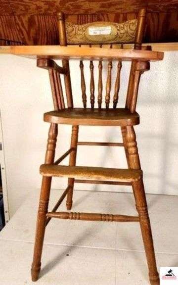 OAK HIGH CHAIR - SPINDLE BACK WITH DESIGN PRESSED BACK DESIGN WITH TRAY - FOOT STEP IS WORN & SHOWS USE WEAR - STURDY & CLASSY - (UPSTAIRS) image